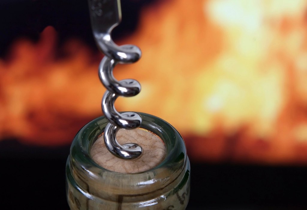 Sacacorchos en la botella, fuego detrás
